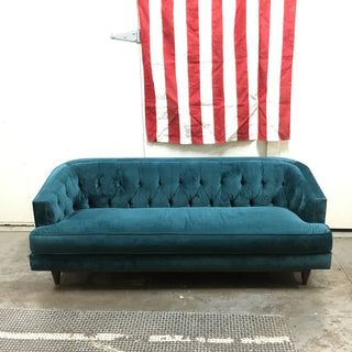 A plush aqua blue-green sofa for sale