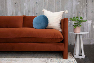Rust colored velvet 70s inspired sofa.