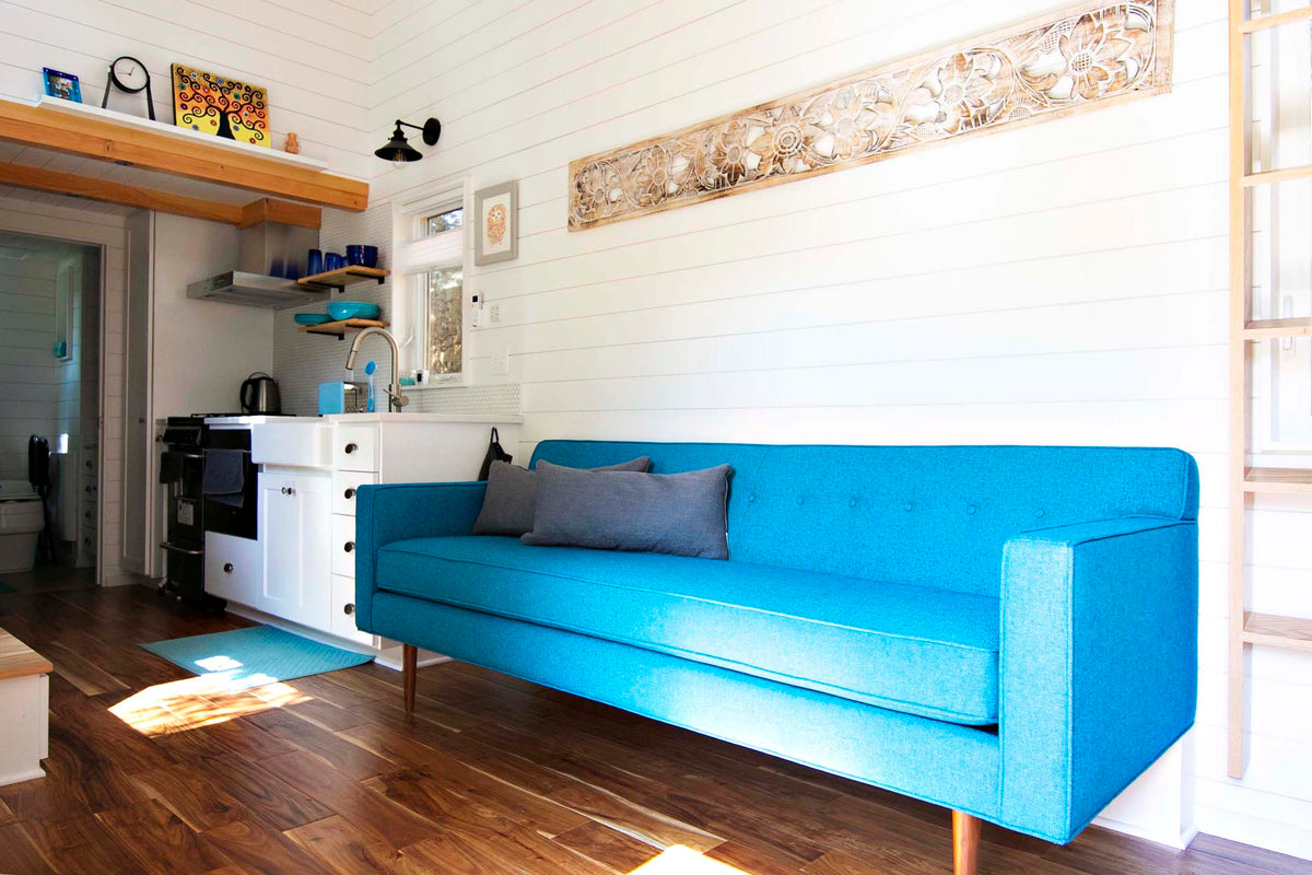 A custom sized Teal blue Sterling sofa from Perch Furniture is the centerpiece of a Portland tiny home.