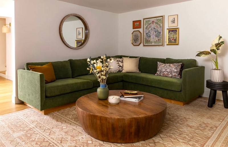 Custom sized, modular sectional Charlie sofa from Portland's best custom sofa shop, Perch Furniture. The sofa is upholstered in a durable green microfiber and located in a basement media room  with a wooden coffee table and decorative mirror.