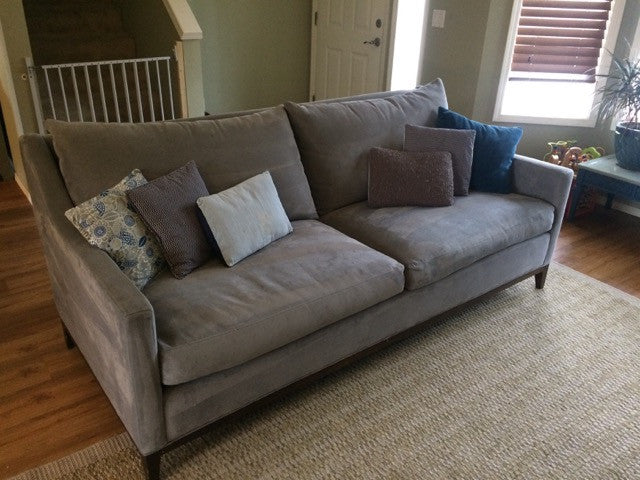 Grey Bel Air sofa in a living room with small decorative pillows on top.