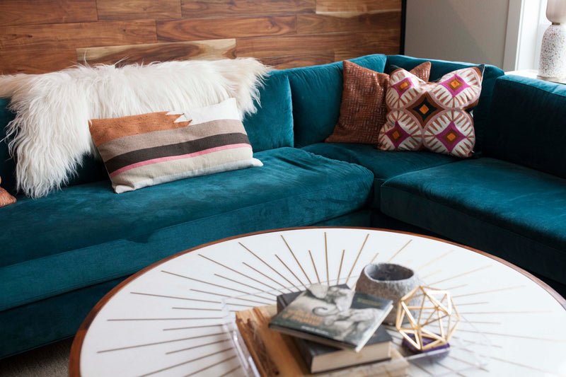 Navy teal couch in a living room setting