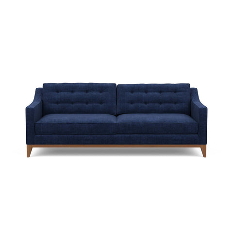 Refined traditional mid-century design is reflected in the Lawson Sofa, pictured here in blue
